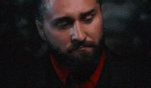 a close up of a man 's face with a beard .