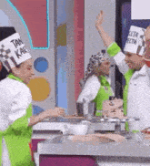 a group of chefs are standing in front of a table with a cake .
