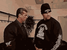 Shrugs Undertaker GIF - Shrugs Undertaker Looking Around GIFs