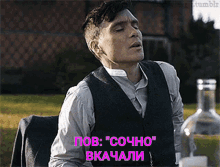 a man in a suit is sitting at a table with a bottle of vodka in the background and says " pov "