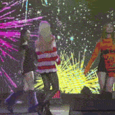 a girl in a striped sweater is dancing on stage