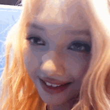 a close up of a woman 's face with a blue background