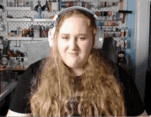 a woman with long blonde hair wearing headphones