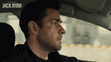 a man in a car with the name jack ryan on the bottom right
