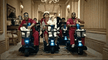 a group of people are riding scooters in a hallway with a basket full of money