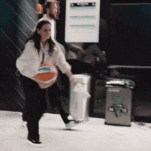 a blurred image of a woman holding a basketball in front of a trash can that says thunder