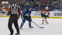 a hockey referee with the number 31 on his back