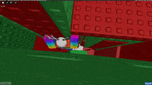 a computer screen shows a rainbow colored cube in a room