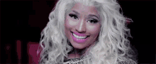 a close up of a woman 's face with white hair and pink lipstick .