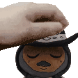 a hand is putting a hat on a stuffed animal .