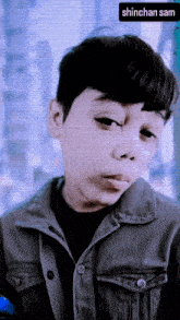 a picture of a young boy with the name shinchan sam on the bottom right