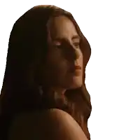 a woman with long brown hair is looking over her shoulder at the camera .
