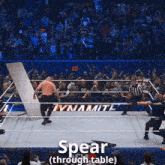 a man in a wrestling ring with the word spear through table