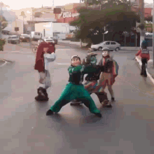a group of children dressed up in costumes are playing on a street .