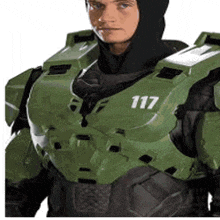 a man in a halo costume is wearing a black hood and a green armor .