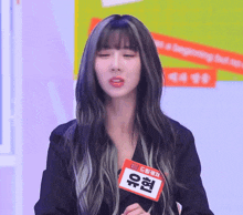 a woman with long hair has a name tag that says ' u ' on it