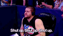 a man wearing headphones and a black tank top says shut up