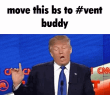 a man in a suit and tie is giving a middle finger