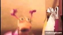a cartoon character is standing in front of a closet with clothes hanging on it .