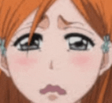 a close up of a cartoon girl 's face with a sad expression .
