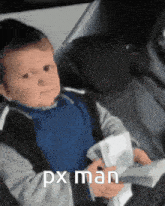 a baby is sitting in a car seat holding a piece of paper that says px man .