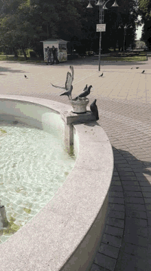 a fountain with a sign that says no smoking on it