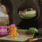 a purple mug that says grind sits on a table next to a stuffed animal