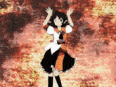 a girl in an orange and black dress is standing in front of a fire background