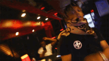 a blurry photo of a person wearing a black shirt with the letters ope on the front