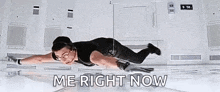 a woman is flying through the air with the words `` me right now '' written on the floor .
