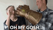 two men holding a glove that says oh my gosh on it