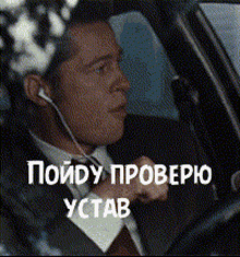 a man in a suit and tie is wearing ear buds while driving