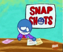 a cartoon character is sitting at a desk with a sign that says snap shots