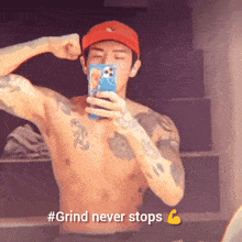 a shirtless man is taking a picture of himself in a mirror with #grind never stops written below him