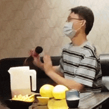 a man wearing a mask is singing into a microphone .