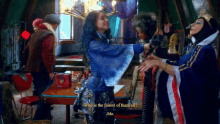 a woman in a blue dress says " who is the fairest of them all ? "