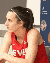 a woman wearing a red jersey that says eve