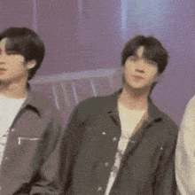 a group of young men are standing next to each other in a room