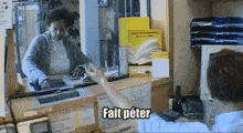 a man standing in front of a counter with a sign that says fait peter on it