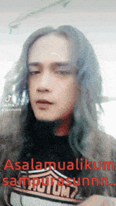 a man with long hair is wearing a shirt that says harley davidson on it