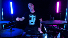 a man wearing a black shirt with the letter j on it