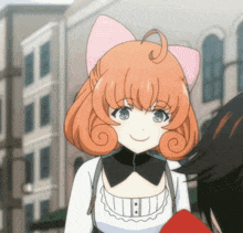 a girl with orange hair and a pink bow on her head is smiling