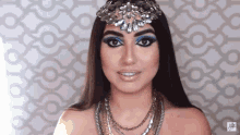 a woman is wearing a necklace and a headpiece with a watermark that says ' nikki ' on it