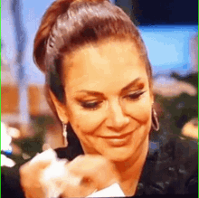 a close up of a woman holding a piece of paper in her hand