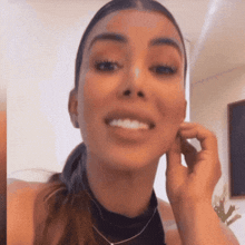 a close up of a woman 's face with a ponytail