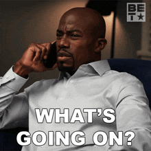 a man talking on a cell phone with the words " what 's going on " above him