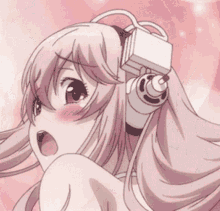 a naked anime girl with pink hair is wearing headphones and looking surprised .