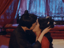a man and woman kissing in a room with a watermark that says 914film