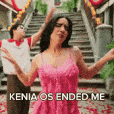 a woman in a pink dress says kenia os ended me in front of a man in a white shirt