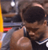 a close up of a basketball player 's face and shoulder